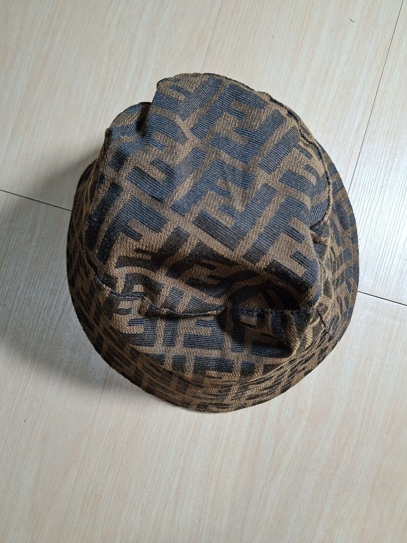 Fendi Zucca FF Logo Brown Bucket Hat (Category: Caps & Hats) located in Baguio. Submitted by restyrille77846 (Listing ID 1468643639, Image 1). Description: - Brand: Fendi - Design: Classic brown and black FF Zucca logo print - Interior: Dark lining with stitched Fendi Roma tag - Features: Structured brim, lightweight fabric - Style: Ultimate streetwear accessory.