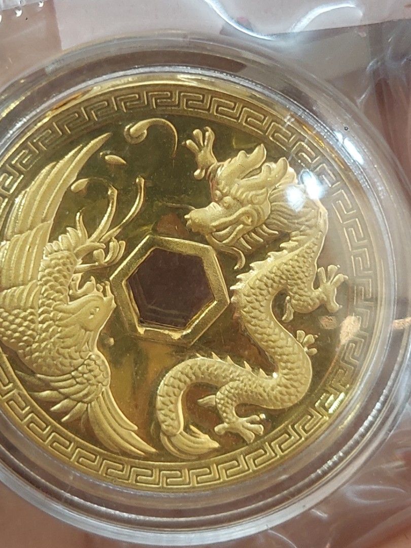 Feng Shui Dragon and Phoenix Gold Coin Token (Category: Currency) located in Manila. Submitted by canydy_1210 (Listing ID 1468653524, Image 1). Description: - Auspicious Chinese geomancy coin featuring a striking dragon and phoenix design - Reverse displays traditional '招财进宝' characters and a 9999 gold marking - Unique hexagonal center opening surrounded by four smaller ancient-style coins - Heavy embossed detailing with a reflective golden surfa