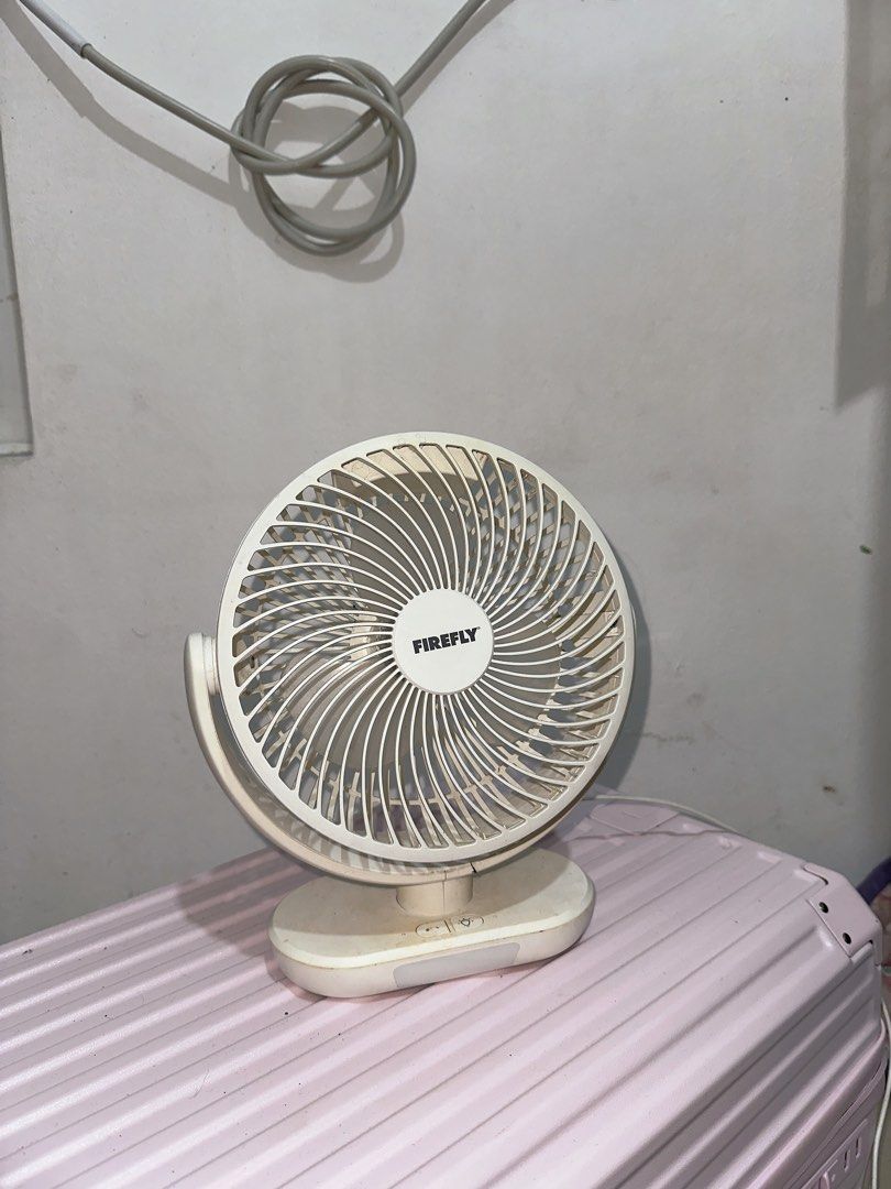 Firefly desk fan oscillating electric fan (Category: Fans) located in Manila. Submitted by yshaaa4758 (Listing ID 1468639673, Image 1). Description: - Brand/Model: Firefly Electric Desk Fan - Color: White - Design: Compact, circular grille for optimal airflow - Controls: Easy-to-use basic buttons on the base - Condition: Shows minor dust and surface dirt from storage, but tested and 100% working - Ideal for: Cooling small desks, tables, or counte