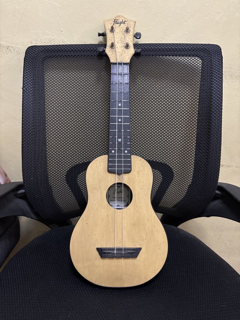 Flight TUS-35 NAT Travel Ukulele (Category: Musical Instruments) located in Malabon City. Submitted by luxgoals (Listing ID 1468520213, Image 1). Description: - Model: Flight TUS-35 NAT Travel Ukulele - Design: Natural wood top, black back/sides/neck, with cute flower fretboard markers - Condition: Body and neck are solid and intact - Notice: Missing 2 strings; tuning pegs have minor wear and rust spots - Ideal for: Beginners looking for a budget