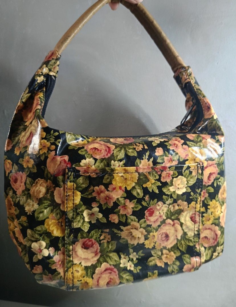 Floral pattern handbag with tan handle (Category: Shoulder Bags) located in Manila. Submitted by sabeloveefzy (Listing ID 1468564978, Image 2). Description: - Color & Pattern: Black with a vibrant floral print - Handles: Stylish tan leather-look handle - Closure: Secure top zipper to keep belongings safe - Storage: Handy exterior back slip pocket - Size: Compact yet spacious enough for daily essentials.