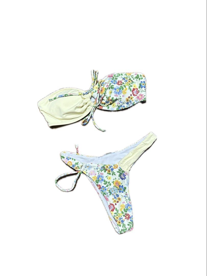 Floral Print Two-Piece Bikini Set with Ties (Category: Bikinis & Swimsuits) located in Manila. Submitted by yumidrobeee (Listing ID 1468546570, Image 1). Description: - Style: Two-piece bandeau bikini with center ruching and tie strings - Print: Colorful floral print on a clean white background with a pastel yellow interior lining - Bottoms: Matching bottoms featuring side ties and adjustable coverage - Material: Lightweight, quick-drying swimwea