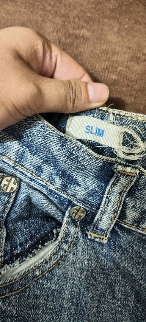 Folded & Hung Slim Jeans Medium Wash (Category: Jeans) located in Manila. Submitted by snz_shop (Listing ID 1468533478, Image 2). Description: - Brand: Folded & Hung - Color/Wash: Medium wash blue denim - Fit: Slim fit with bootcut flared lower legs - Details: Contrast yellow stitching and branded metallic rivets - Branding: Leather patch logo on the back waistband - Design: Classic five-pocket style with zip fly closure.