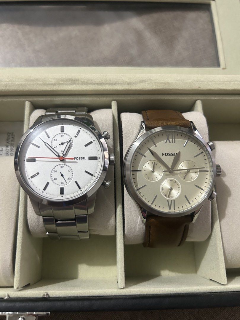 Fossil watch (Category: Men's Watches) located in Caloocan City. Submitted by chewy1129 (Listing ID 1468548292, Image 1). Description: - Bundle of two authentic Fossil watches - Watch 1: Silver-tone metal bracelet, white dial with red second hand, and three sub-dials (Clean condition) - Watch 2: Brown leather strap, champagne-colored dial with Roman numerals at 12 and 6, and three sub-dials (Shows minor creasing and wear near the tip) - Great eve
