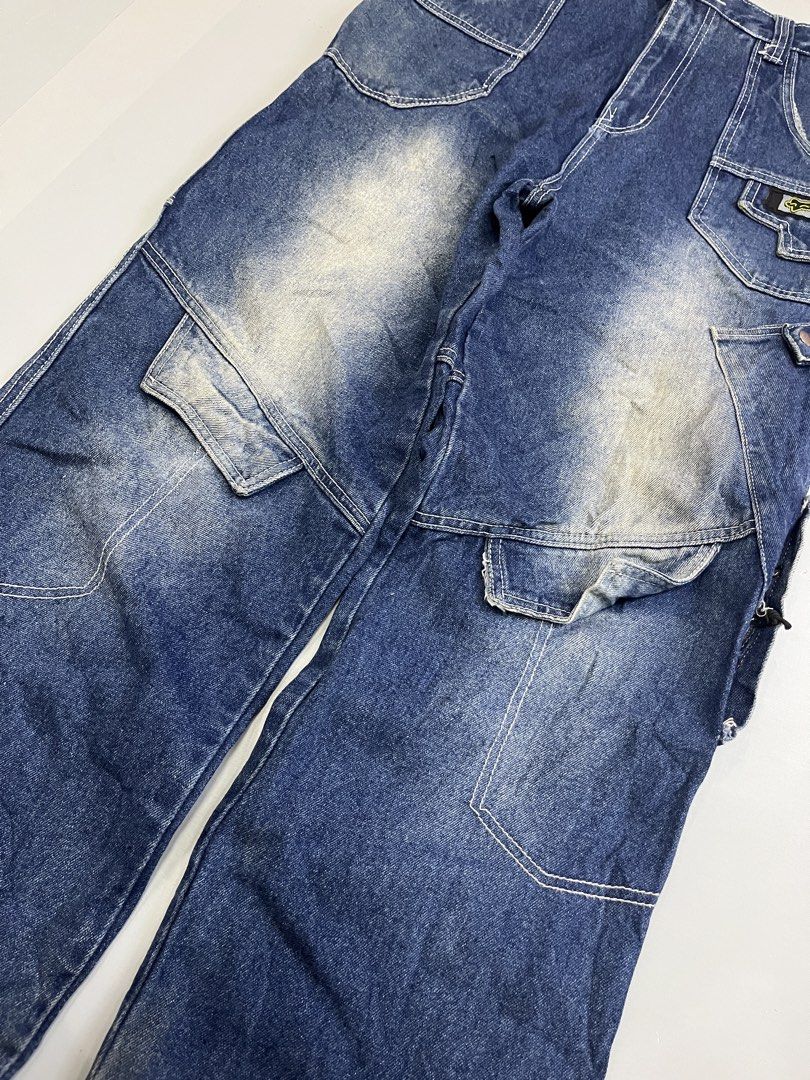 Fox Racing Cargo Denim Jeans Blue Size 32 (Category: Jeans) located in Mabalacat. Submitted by aas_thriftfings (Listing ID 1468578135, Image 3). Description: - Brand: Fox Racing - Style: Cargo denim jeans with multi-pocket utility design - Color: Blue with contrast stitching - Size: 32 waist (42 length on tag) - Details: Large embroidered script logo on back leg, patch logo on front pocket, zippered back pockets, and metal snap details - Conditio
