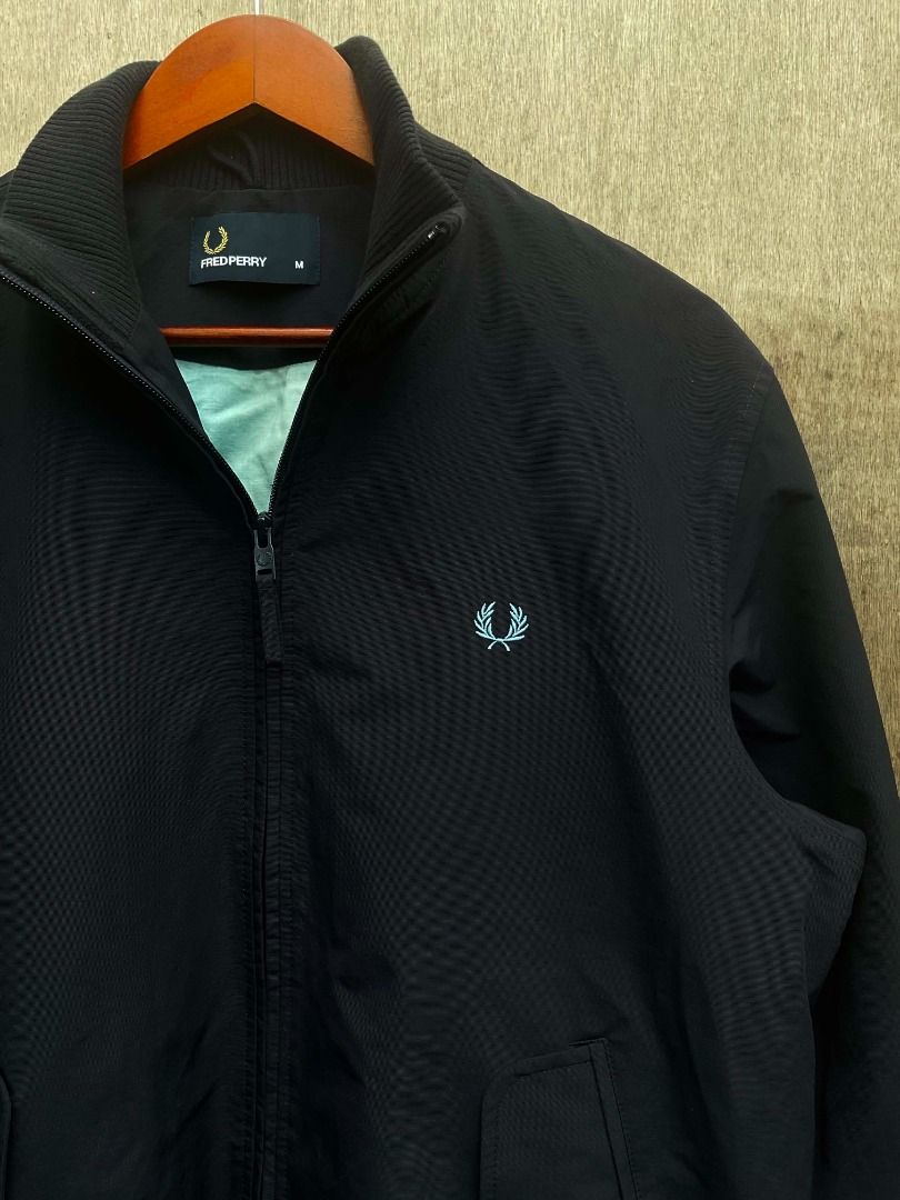 Fred Perry Bomber Jacket Size M (Category: Coats, Jackets and Outerwear) located in Talisay. Submitted by justindanielle17 (Listing ID 1468614727, Image 3). Description: -Authentic -22 inches width -26 inches length -Excellent Condition - Brand: Fred Perry - Item: Zip-up Bomber Jacket - Color: Dark Navy Blue with light blue inner lining - Size: Medium - Details: Contrast blue and maroon stripes on ribbed hem and cuffs, signature embroidered laure