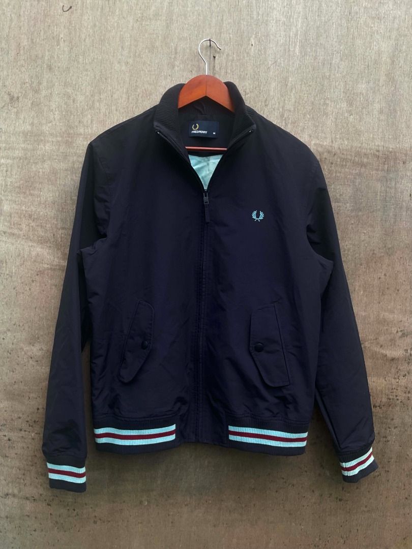 Fred Perry Bomber Jacket Size M (Category: Coats, Jackets and Outerwear) located in Talisay. Submitted by justindanielle17 (Listing ID 1468614727, Image 2). Description: -Authentic -22 inches width -26 inches length -Excellent Condition - Brand: Fred Perry - Item: Zip-up Bomber Jacket - Color: Dark Navy Blue with light blue inner lining - Size: Medium - Details: Contrast blue and maroon stripes on ribbed hem and cuffs, signature embroidered laure