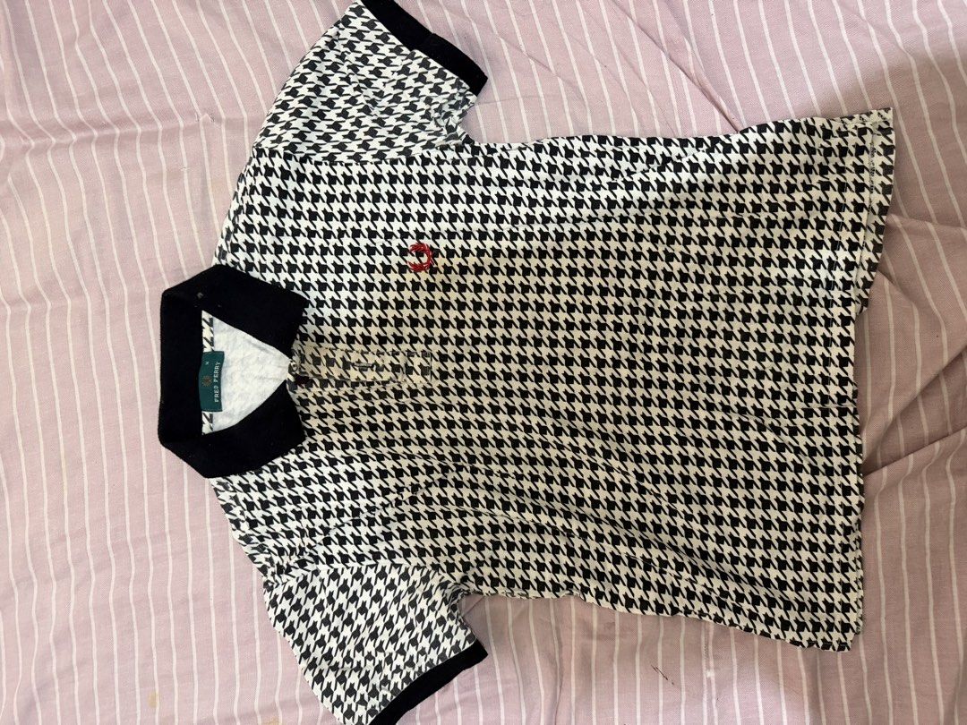 Fred Perry Houndstooth Polo Shirt Black White M (Category: Tshirts & Polo Shirts ) located in Minglanilla. Submitted by twodegrees (Listing ID 1468538559, Image 3). Description: - Brand: Fred Perry - Style: Classic polo shirt with black and white houndstooth pattern - Size: M - Material: 100% cotton - Details: Black collar, black sleeve cuffs, standard three-button placket, and iconic red laurel wreath embroidery - Origin: Made in Hong Kong - Con