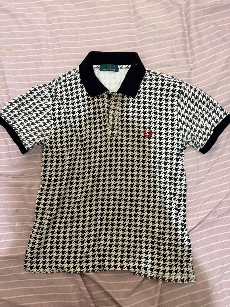 Fred Perry Houndstooth Polo Shirt Black White M (Category: Tshirts & Polo Shirts ) located in Minglanilla. Submitted by twodegrees (Listing ID 1468538559, Image 2). Description: - Brand: Fred Perry - Style: Classic polo shirt with black and white houndstooth pattern - Size: M - Material: 100% cotton - Details: Black collar, black sleeve cuffs, standard three-button placket, and iconic red laurel wreath embroidery - Origin: Made in Hong Kong - Con