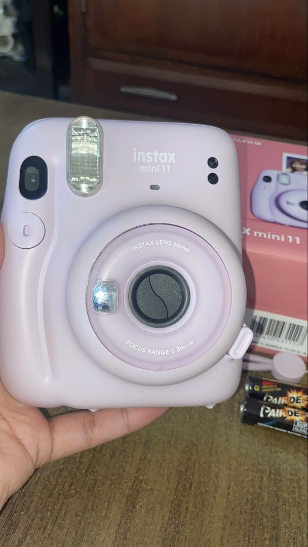 FUJIFILM Instax Mini 11 (Category: Cameras) located in Mabalacat. Submitted by purple.dust (Listing ID 1468551485, Image 2). Description: * Brand: Fujifilm * Model: Instax Mini 11 * Color: Lilac Purple * Type: Instant film camera * Condition: Excellent condition * Working condition: Fully functional, takes photos normally * Battery: Working * Inclusions: * Instax Mini 11 camera * Original box * Clear protective camera case * Purple wrist strap * 