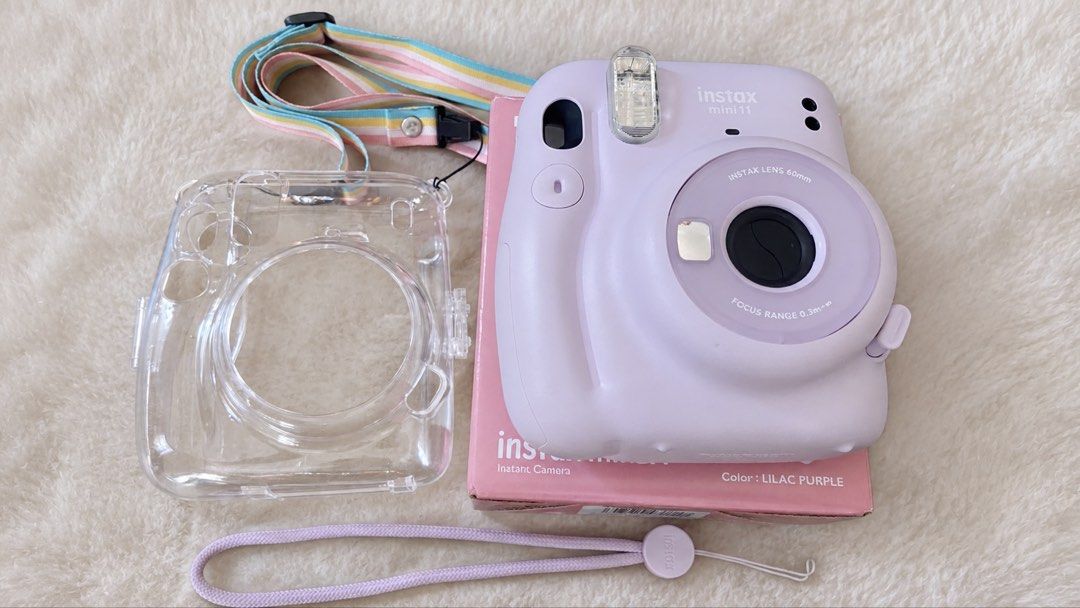 FUJIFILM Instax Mini 11 (Category: Cameras) located in Mabalacat. Submitted by purple.dust (Listing ID 1468551485, Image 1). Description: * Brand: Fujifilm * Model: Instax Mini 11 * Color: Lilac Purple * Type: Instant film camera * Condition: Excellent condition * Working condition: Fully functional, takes photos normally * Battery: Working * Inclusions: * Instax Mini 11 camera * Original box * Clear protective camera case * Purple wrist strap * 