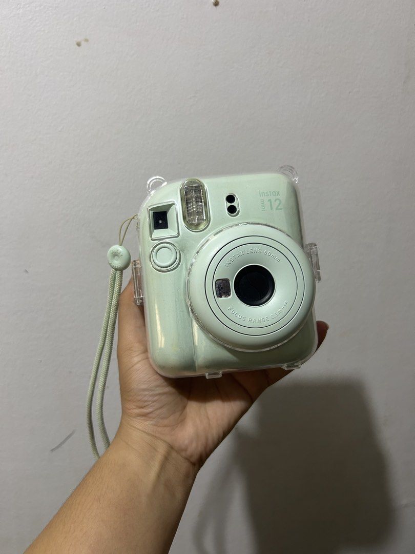 Fujifilm Instax Mini 12 Pastel Green with Case (Category: Cameras) located in Puerto Princesa. Submitted by kthjbs (Listing ID 1468520461, Image 1). Description: - Model: Fujifilm Instax Mini 12 - Color: Pastel Green - Condition: Tested and 100% working - Inclusions: Clear plastic protective case and matching wrist strap - Features: Prints great instant photos (sample shots shown in photos) - Ideal for: Trips, parties, and everyday snapshots - Re