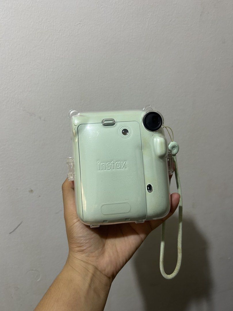 Fujifilm Instax Mini 12 Pastel Green with Case (Category: Cameras) located in Puerto Princesa. Submitted by kthjbs (Listing ID 1468520461, Image 2). Description: - Model: Fujifilm Instax Mini 12 - Color: Pastel Green - Condition: Tested and 100% working - Inclusions: Clear plastic protective case and matching wrist strap - Features: Prints great instant photos (sample shots shown in photos) - Ideal for: Trips, parties, and everyday snapshots - Re