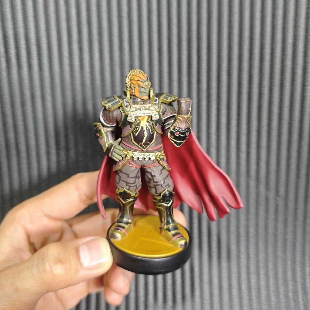 Ganondorf amiibo (Category: In-Game Products) located in Quezon City. Submitted by shopme_gadget30 (Listing ID 1468541403, Image 1). Description: This figure is the Ganondorf amiibo from the Super Smash Bros. Series by Nintendo. Representing the iconic King of Evil from The Legend of Zelda, this particular design highlights his heavy armor and flowing cape inspired by his appearance in The Legend of Zelda: Twilight Princess • Character: Ganondorf