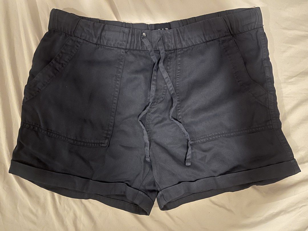 Gap Dark Gray Drawstring Casual Shorts (Category: Shorts) located in Manila. Submitted by vees.shop (Listing ID 1468685103, Image 1). Description: - Brand: Gap - Color: Dark gray - Waist: Elastic with adjustable drawstring - Design: Rolled cuffs at the hem - Pockets: Two front patch pockets and two back pockets - Style: Comfortable everyday wear, easy slip-on - Condition: Clean fabric with solid stitching throughout - Mode of Payment: Gcash or BP