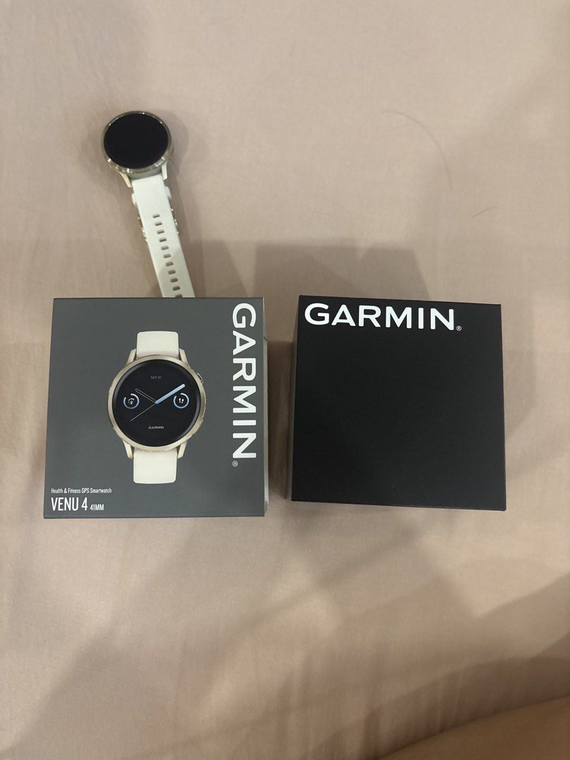 Garmin Venu 4 41MM (Category: Wearables & Smart Watches) located in Manila. Submitted by cavemandraws (Listing ID 1468518936, Image 1). Description: - Brand: Garmin - Model: Venu 4 (41mm) - Color: White with metallic bezel - Condition: Excellent, lightly used - Inclusions: Original box and packaging - Features: Health & fitness GPS tracking, vibrant display, quick-release strap - Meetup Location: Starbucks, 243 Matalino St, Quezon City Woman owne