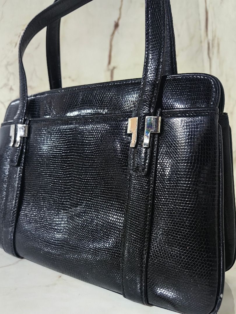 Genuine Lizard Skin Handbag (Category: Shoulder Bags) located in Tarlac. Submitted by jeremiah.curator.2026 (Listing ID 1468536853, Image 3). Description: - Color & Texture: Elegant Black Lizard Skin Leather - Hardware: Modern silver-tone accents on front straps - Closure: Secure kiss-lock top closure - Interior: Dark lining equipped with a convenient zippered pocket - Structure: Sturdy rectangular base maintains bag shape - Handles: Convenient d