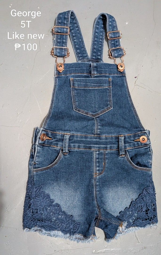 George Denim Overalls Shorts Size 5T (Category: Babies & Kids Fashion) located in Tanay. Submitted by misyelleysim (Listing ID 1468614919, Image 1). Description: - Brand/Size: George, Size 5T - Material/Color: Blue wash denim with raw frayed hem cuffs - Details: Cute blue lace overlay on the cuffs, rose gold adjustable straps and buttons - Pockets: Front bib pocket, side pockets, and belt loops - Condition: Great pre-loved outfit piece.