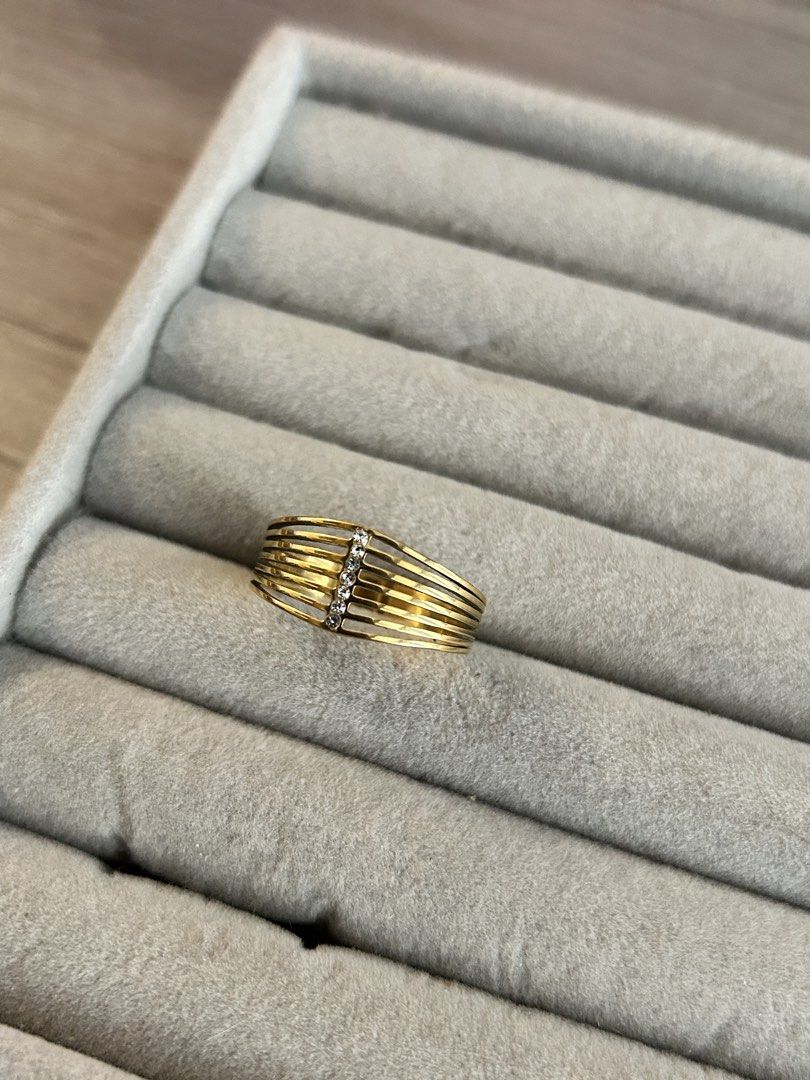 Gold multi-band ring with crystal accents (Category: Rings) located in Manila. Submitted by elonlineshop (Listing ID 1468500308, Image 3). Description: - Design: Six parallel bands connected by a vertical line of sparkling crystals - Style: Bold statement ring that sits wide on the finger - Color/Finish: Warm yellow gold finish - Perfect for adding a touch of elegance to any outfit! -Stainless Steel.