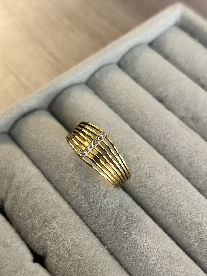 Gold multi-band ring with crystal accents (Category: Rings) located in Manila. Submitted by elonlineshop (Listing ID 1468500308, Image 2). Description: - Design: Six parallel bands connected by a vertical line of sparkling crystals - Style: Bold statement ring that sits wide on the finger - Color/Finish: Warm yellow gold finish - Perfect for adding a touch of elegance to any outfit! -Stainless Steel.