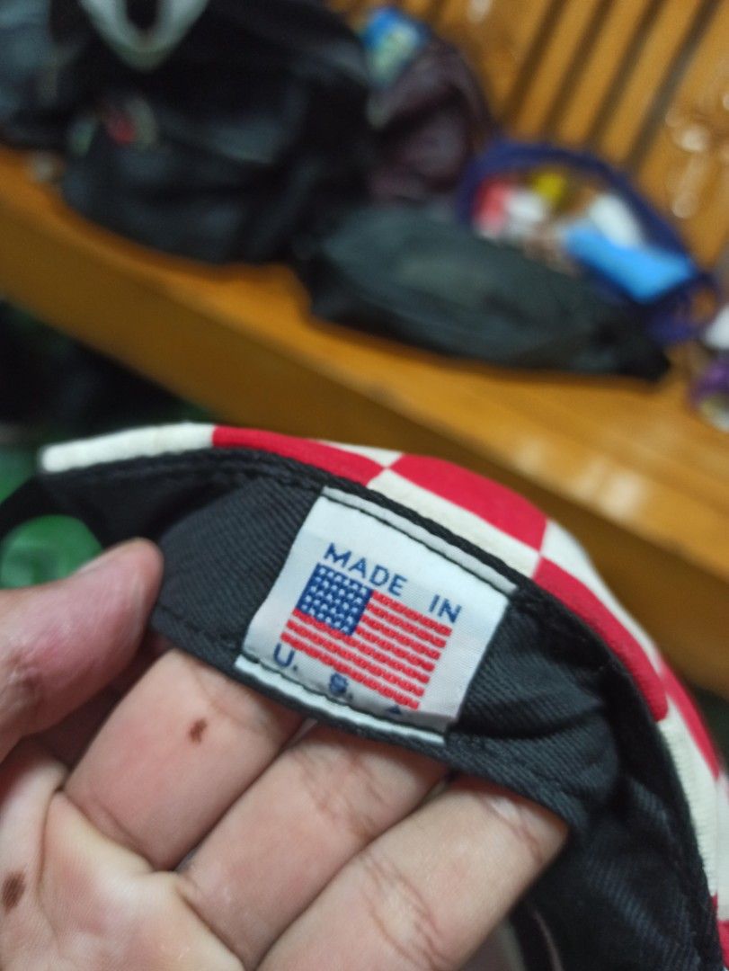 GOLF Wang Red and White Checkerboard Hat with Light Blue Brim (Category: Caps & Hats) located in Tagbilaran City. Submitted by delasierra39181 (Listing ID 1468586728, Image 3). Description: - Brand: GOLF Wang - Design: Red and white checkerboard pattern with light blue brim - Details: Contrasting rectangular GOLF logo patch on front - Back: Adjustable black strap with yellow GOLF tag - Origin: Made in USA (interior flag label) - Condition: Minor 