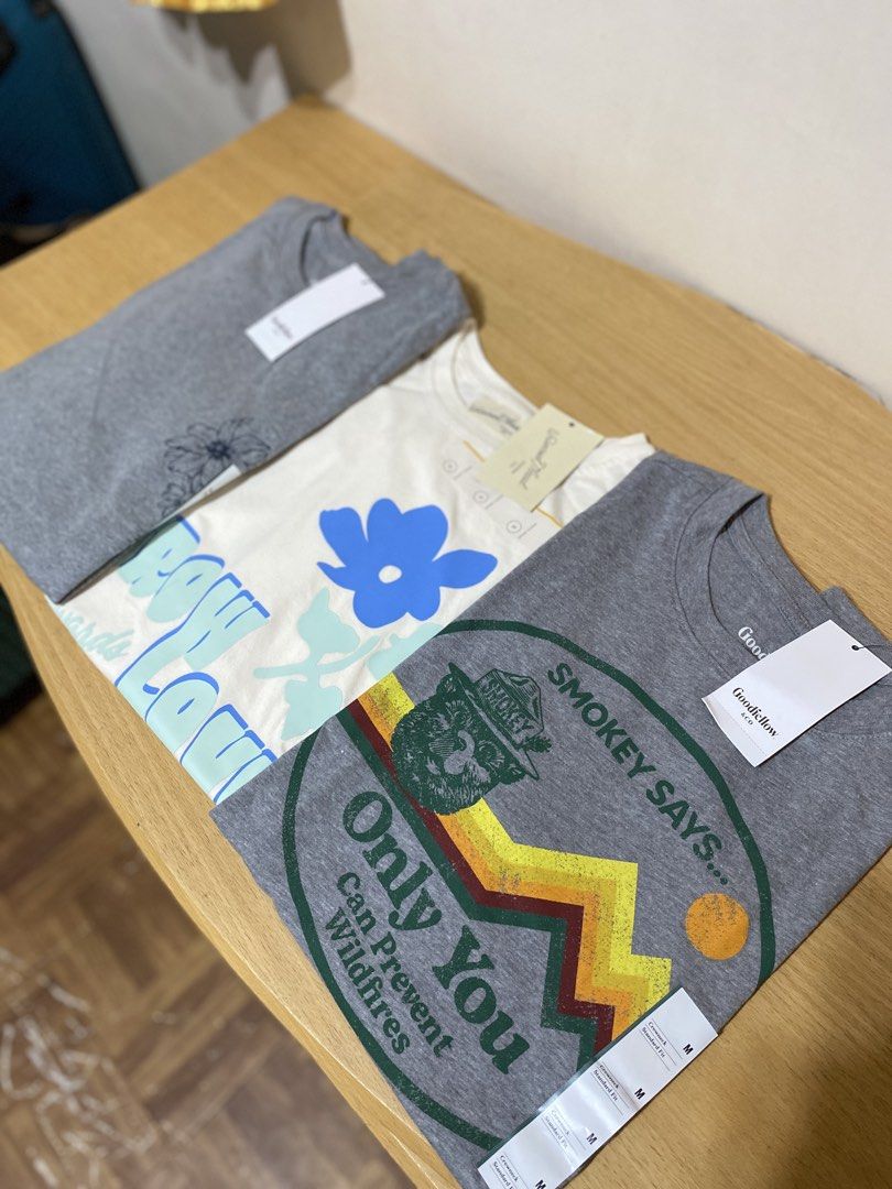 Goodfellow & Co Graphic T-Shirts Bundle L-XL (Category: Shirts) located in Batangas. Submitted by lux_kimmy (Listing ID 1468500422, Image 1). Description: - Brand: Goodfellow & Co - Size: L-XL body frame - Quantity: Bundle of 3 graphic t-shirts - Condition: Brand new with tags attached - Designs: Heather grey Smokey Bear, cream with blue flower and 'Grow' text, and dark grey heather with floral sketch.