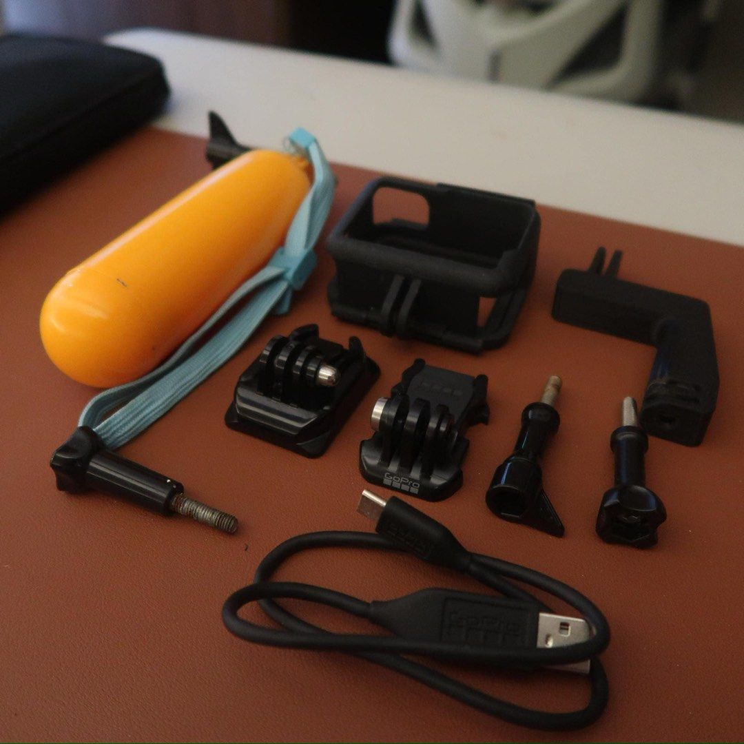 GoPro Hero12 Black with Accessories and Box (Category: Video Cameras) located in Manila. Submitted by maira_lucero (Listing ID 1468662969, Image 2). Description: - Item: GoPro Hero12 Black Action Camera - Condition: Excellent, ready for use - Included: Original box and USB-C charging cable - Accessories: Protective housing frame, yellow floating handle grip - Mounts: Several mounting buckles, thumbscrews, and an angled mount piece - Ideal For: Tr