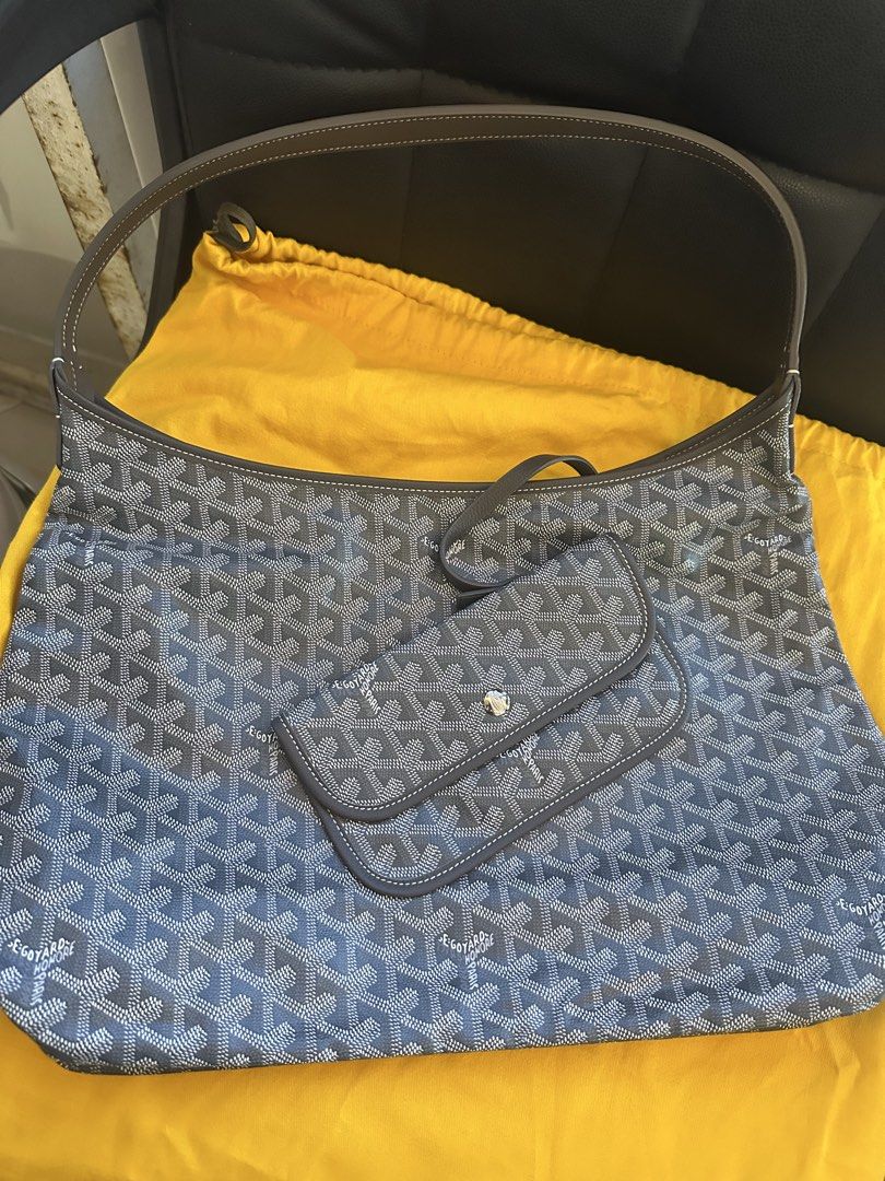 Goyard Hobo Shoulder Bag with Pouch Grey (Category: Luxury Bags & Wallets) located in Manila. Submitted by jmsluxe2026 (Listing ID 1468593166, Image 1). Description: Grey Goyard shoulder bag featuring the signature chevron print pattern. Single leather handle strap over top. Includes a matching small detachable pouch attached by a strap with a snap button closure. Yellow dust bag included in background. Clean structured hobo shape..