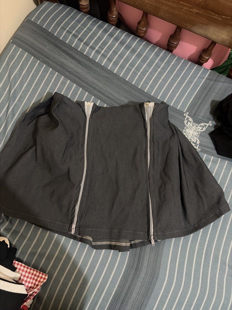 gray mini skirt (Category: Jeans) located in Quezon City. Submitted by pika.lex (Listing ID 1468510537, Image 1). Description: - Color: Dark grey or black - Length: Full length with a visible top zipper - Fabric: Sturdy, matte texture - Condition: Noticeable fraying and loose threads near the waistband and zipper track - Note: Might need a quick trip to the tailor for minor repairs.