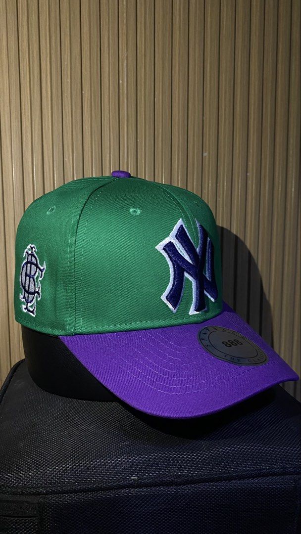 Green and Purple Yankees Snapback Hat (Category: Caps & Hats) located in Manila. Submitted by _kyndzgrt (Listing ID 1468682497, Image 2). Description: - Color: Green and Purple - Team: NY Yankees embroidered logo on front with dark blue and white outline - Details: Extra side panel embroidery and flat brim with original metallic sticker - Fit: Adjustable snap closure at the back - Condition: Excellent/New.