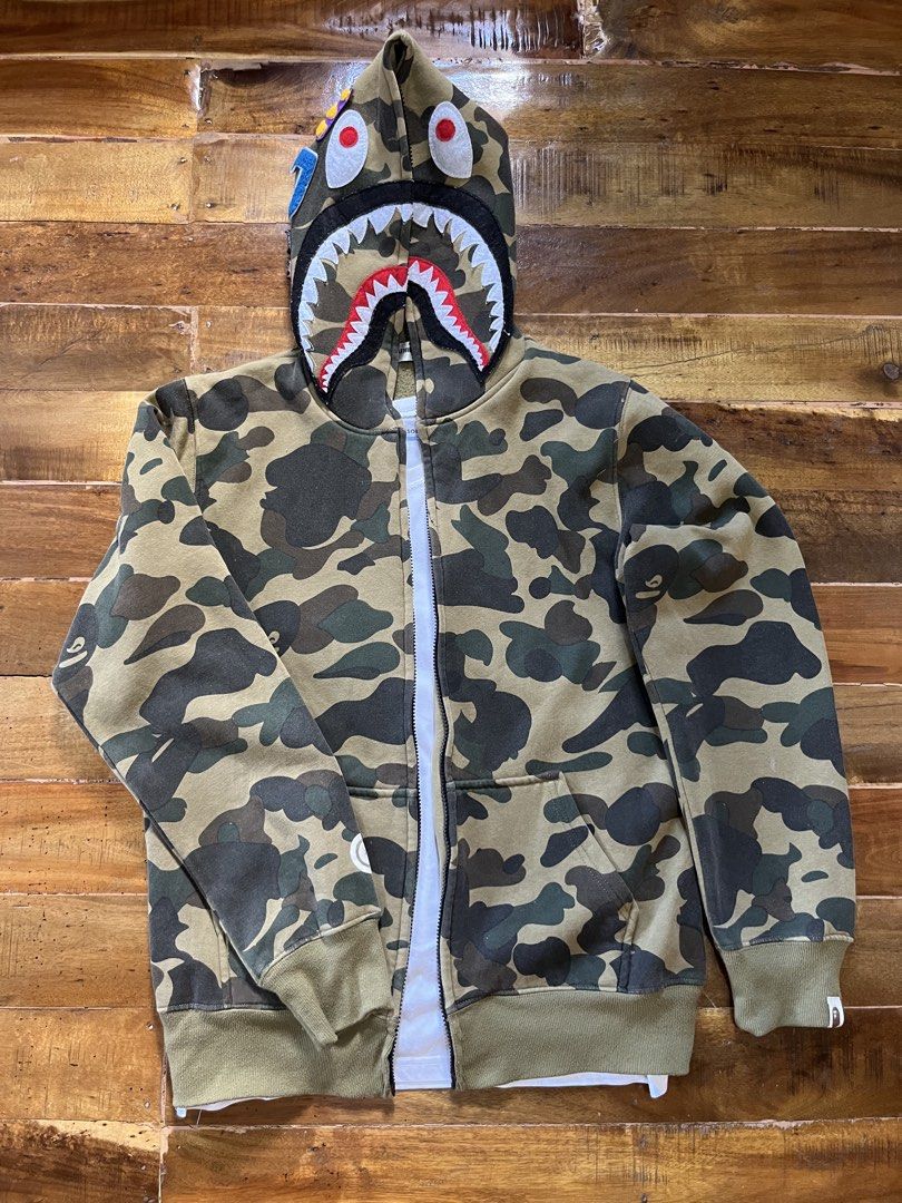Green camou Bapeshark (Category: Coats, Jackets and Outerwear) located in Manila. Submitted by cjzgarments_ (Listing ID 1468527351, Image 2). Description: 📌(Off only), but still a steal cuz it’s heavy cotton, the color is 9/10, and broken zippers ☺️.