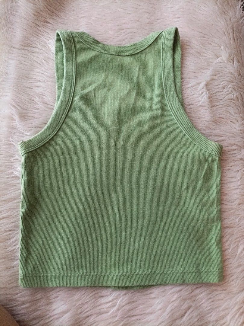 Green Ribbed Knit Tank Top (Category: Sleeveless) located in Pasig City. Submitted by sandacecloset (Listing ID 1468711134, Image 3). Description: - Color: Green - Size: XS - Material: 95% Cotton, 5% Spandex (soft & stretchy) - Design: Scoop neckline and racerback style - Condition: Lightly used / Great basic everyday piece.