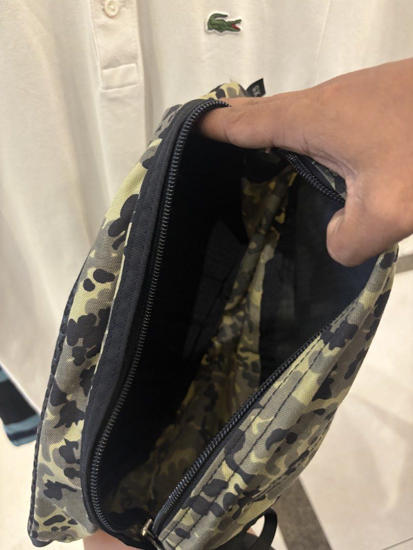 Gregory Camo Waist Pack (Category: Belt bags, Clutches and Pouches) located in Manila. Submitted by jeromskito66462 (Listing ID 1468676596, Image 3). Description: - Brand: Gregory - Style: Waist pack / Fanny pack - Design: Green camo pattern with black webbing strap and zippers - Origin: Made in USA tag attached - Comfort: Breathable black mesh backing on the rear - Interior: Spacious main compartment with clean fabric lining - Condition: Clean a
