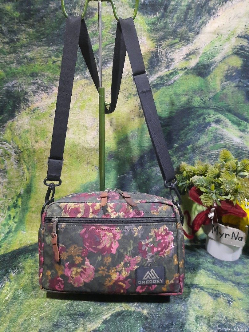 Gregory Floral Shoulder Bag (Category: Sling Bags) located in Baguio. Submitted by klayblakeb87803 (Listing ID 1468594141, Image 1). Description: - Brand: Gregory - Design: Vibrant floral print on dark green background - Materials: 100% polyester exterior, 100% nylon interior - Strap: Adjustable black shoulder strap - Pockets: Main zippered compartment, front zip pocket, and interior organizational slip pockets - Origin: Made in the Philippines -