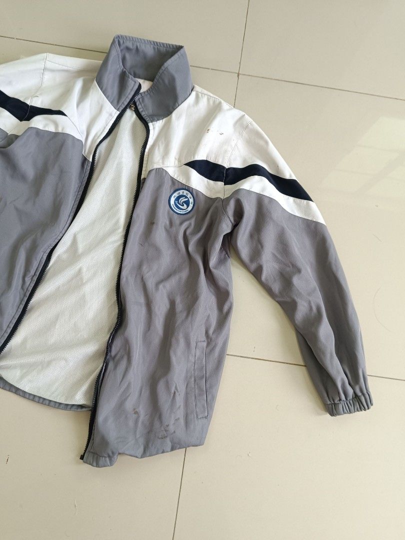 Grey & White Zip-Up Windbreaker Jacket (Category: Coats, Jackets and Outerwear) located in Valenzuela. Submitted by justgorjas (Listing ID 1468502186, Image 3). Description: Women's / Unisex Outerwear (Zip-up Jacket / Windbreaker) Feng Ming High School - School Uniform / Varsity Windbreaker) Taiwan (Imported) Estimated Medium to Large (Fits comfortable M–L, relaxed fit) Color: Light Grey / White / Navy Blue Material: Lightweight Polyester Outer /