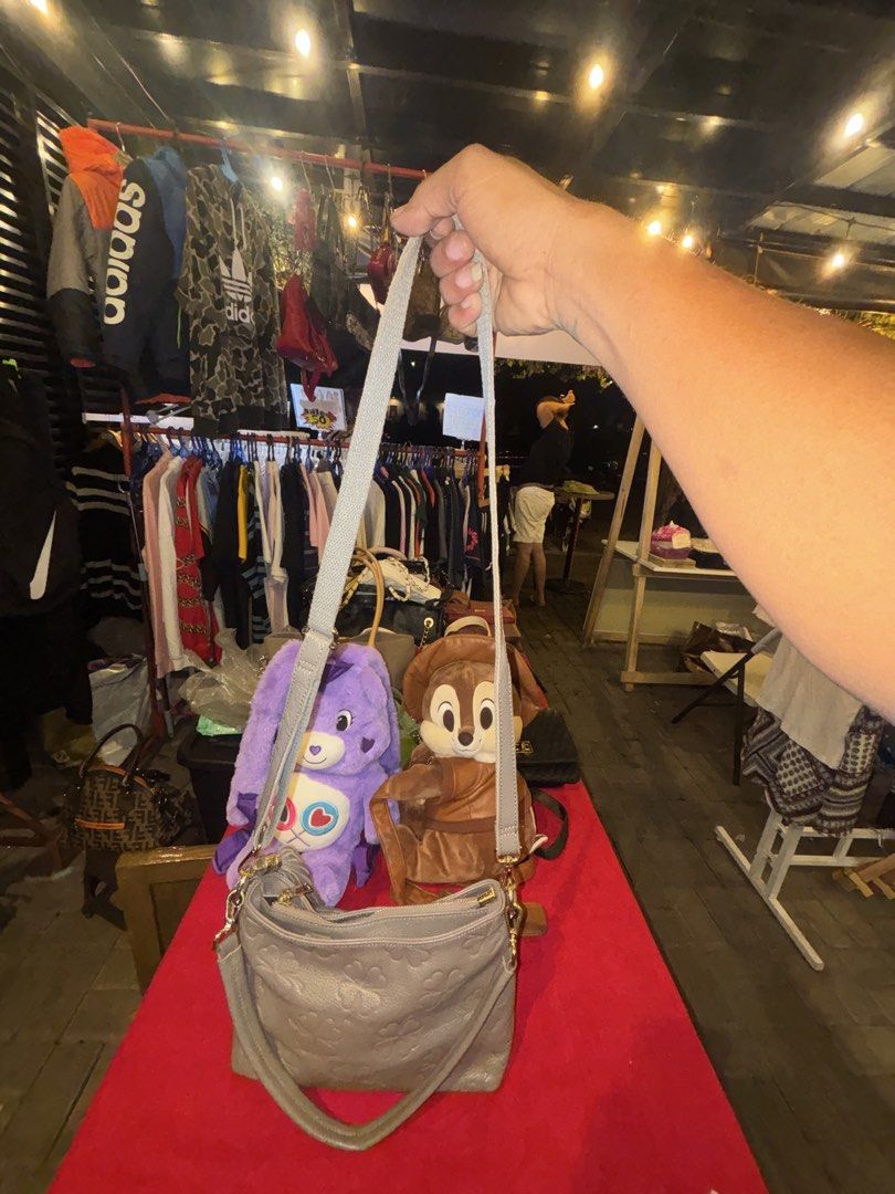Grey clover patterned leather shoulder bag with tassel (Category: Shoulder Bags) located in Manila. Submitted by jeromskito66462 (Listing ID 1468674003, Image 3). Description: - Grey pebbled leather with debossed clover pattern - Includes a matching short strap and an adjustable crossbody strap - Features elegant gold-tone hardware and a stylish tassel zipper pull on the back pocket - Fabric-lined interior equipped with secure zipped compartments