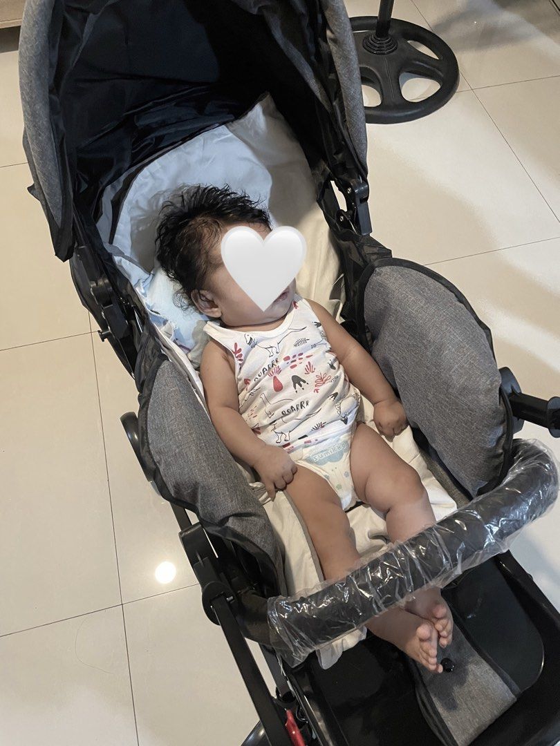 Grey foldable baby stroller pushchair (Category: Strollers) located in Caloocan City. Submitted by anjpot (Listing ID 1468563022, Image 3). Description: - Color: Sleek grey with a sturdy black metal frame - Comfort: Padded seat with adjustable harness straps for safety - Design: Double handlebar setup and protective canopy - Portability: Folds down compact for easy storage and travel - Ideal for: Infants and toddlers, perfect for daily use.