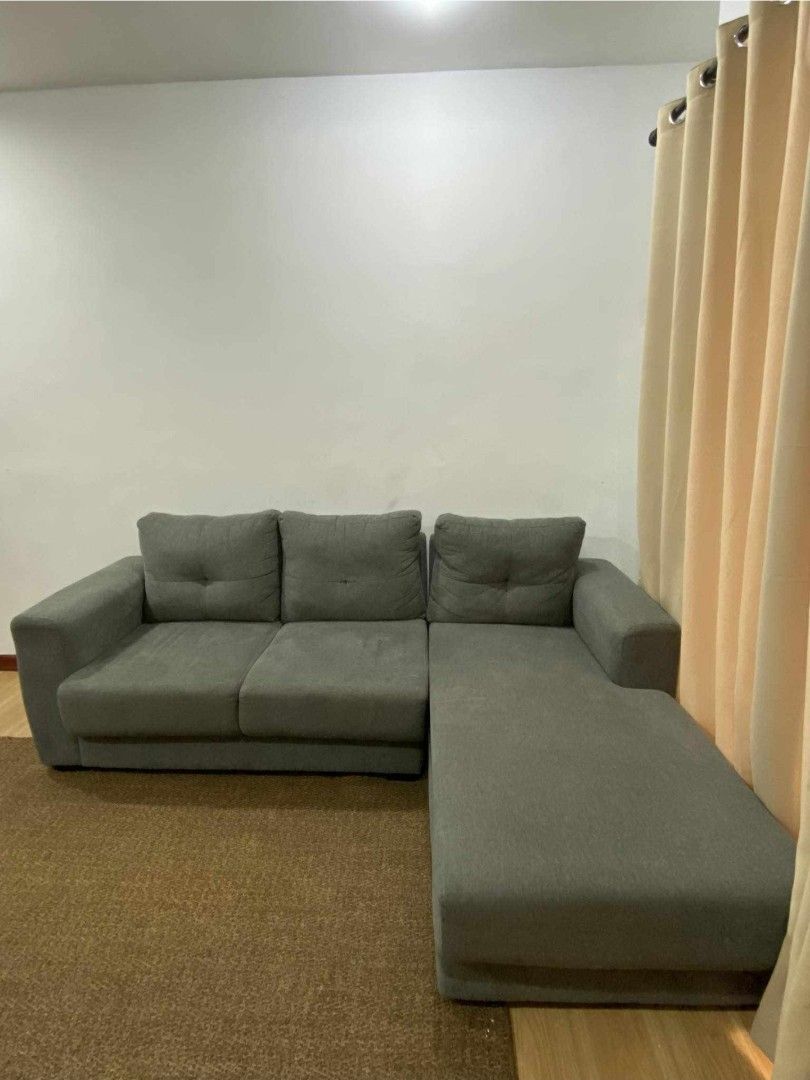 Grey L-Shaped Sectional Sofa with Chaise (Category: Sofas) located in Taytay. Submitted by camsyron (Listing ID 1468553397, Image 2). Description: - Type: Grey L-shaped sectional sofa with chaise lounge extension - Color: Solid dark grey fabric upholstery - Features: Comfortable cushioned backrests with stylish button-tufted details - Size: Approximately 160 cm across - Condition: Clean, well-maintained, and ready for use - Ideal for: Living room