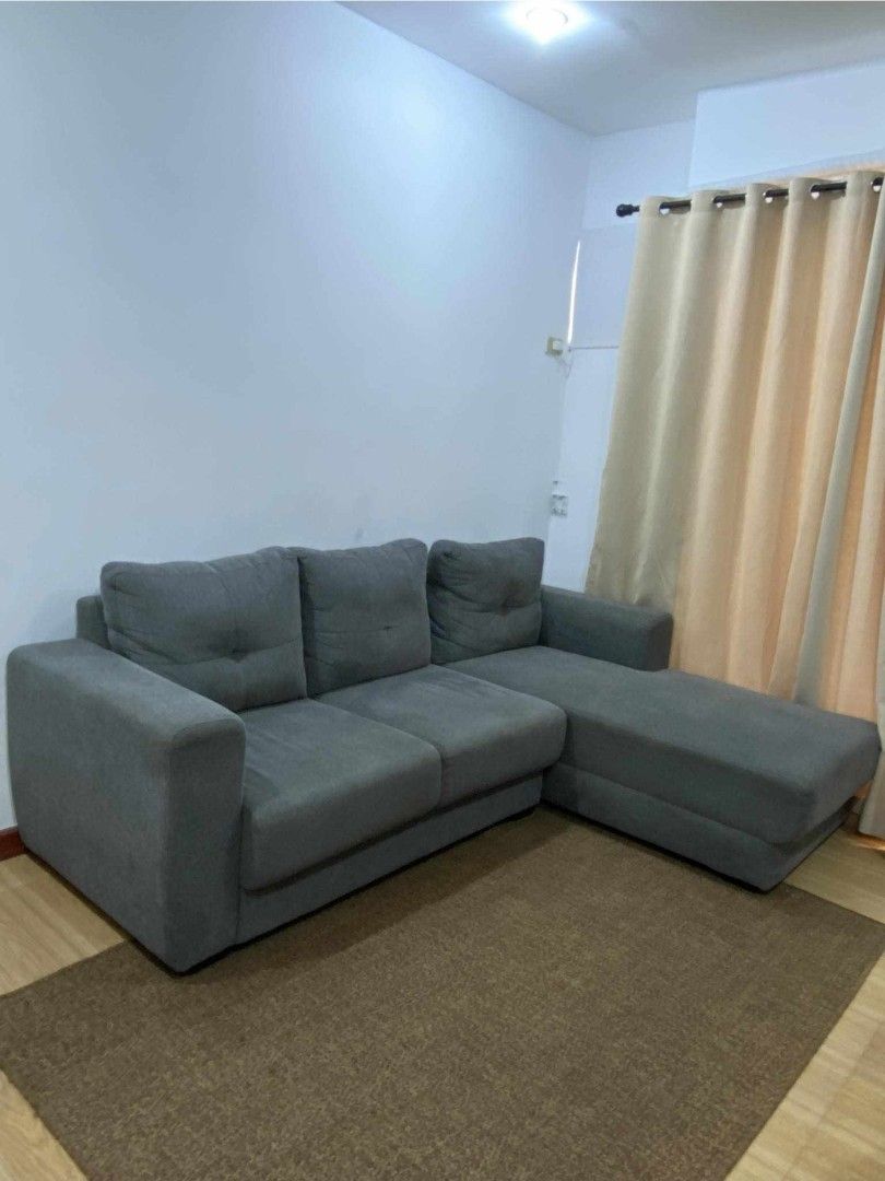 Grey L-Shaped Sectional Sofa with Chaise (Category: Sofas) located in Taytay. Submitted by camsyron (Listing ID 1468553397, Image 1). Description: - Type: Grey L-shaped sectional sofa with chaise lounge extension - Color: Solid dark grey fabric upholstery - Features: Comfortable cushioned backrests with stylish button-tufted details - Size: Approximately 160 cm across - Condition: Clean, well-maintained, and ready for use - Ideal for: Living room