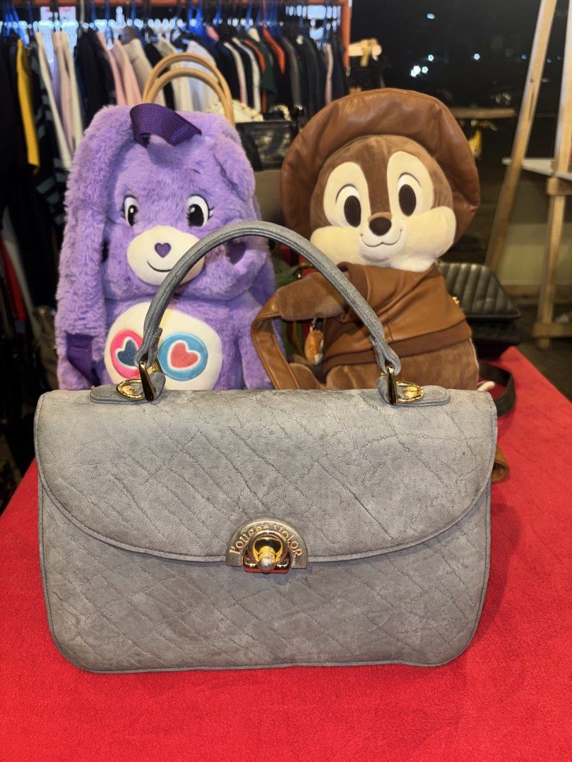 Grey Quilted Top Handle Handbag (Category: Tote Bags) located in Manila. Submitted by jeromskito66462 (Listing ID 1468674775, Image 1). Description: - Color: Grey - Material: Soft textured with diagonal stitching - Hardware: Gold-tone twist lock closure - Storage: Back zipper pocket and inside zipper compartment - Structure: Stands upright easily with a clean interior - Style: Top handle handbag.