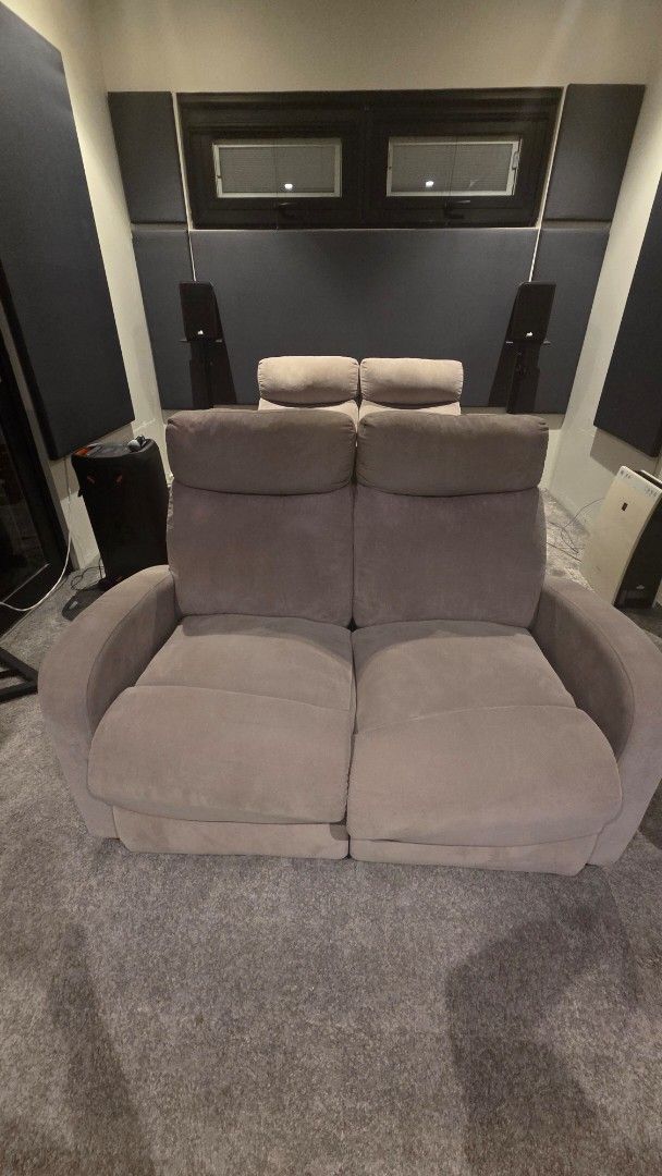 Grey Two-Seater Recliner Sofa (Category: Sofas) located in Pasig City. Submitted by annsvault (Listing ID 1468603087, Image 1). Description: - Color: Grey - Seating: Comfortably fits 2 people - Support: Plush cushions, padded armrests, and high backs for head support - Design: Soft upholstery with clean edge stitching - Frame: Sturdy and durable build - Size: Compact, ideal for small living rooms or media spaces.