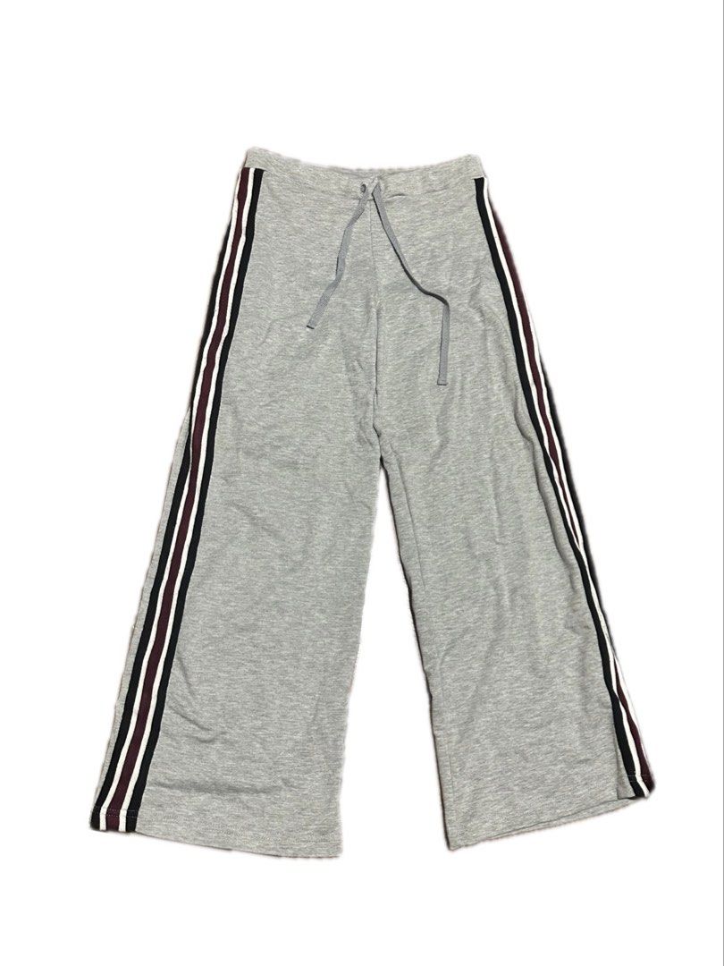 Grey wide-leg sweatpants with side stripes and drawstring (Category: Other Bottoms) located in Manila. Submitted by yumidrobeee (Listing ID 1468546127, Image 1). Description: - Colour: Grey with maroon, black, and white side stripes - Material: Soft, breathable knit cotton - Fit: Relaxed, wide-leg cut with an easy pull-on design - Waistband: Adjustable matching drawstring - Ideal for: Casual wear and cozy lounging.