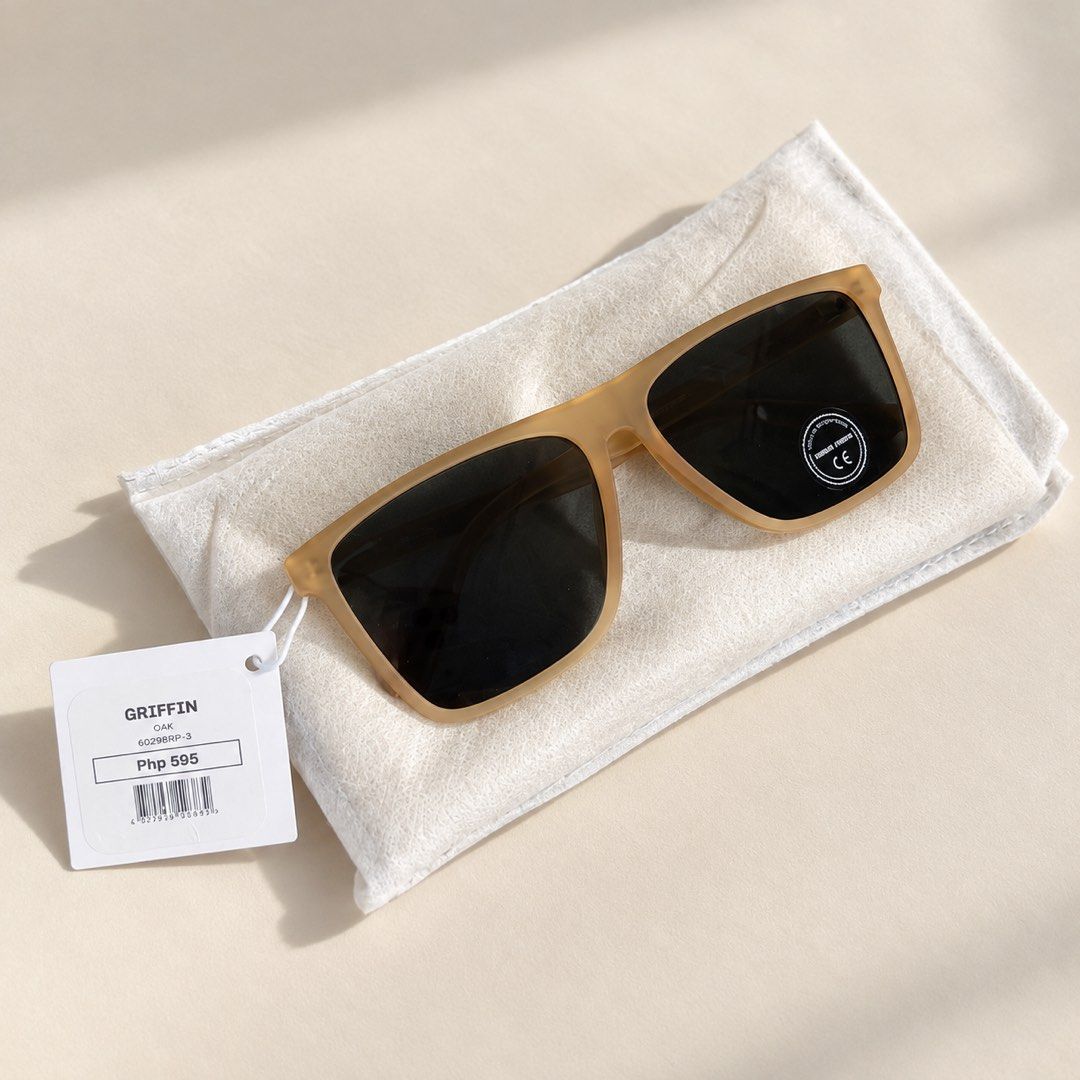 Griffin Oak Sunglasses (Category: Sunglasses & Eyewear) located in Manila. Submitted by byanks (Listing ID 1468588457, Image 1). Description: - Brand: Griffin - Model: 60298RP-3 - Colorway: Oak (Matte tan frames with dark tinted lenses) - Condition: Brand new, unworn, with original lens sticker and white tag (Php 595) - Inclusions: Comes with a soft felt pouch for storage.