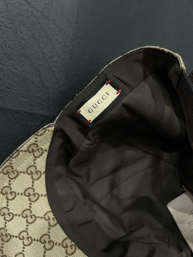 Gucci GG Canvas Baseball Cap Size L (Category: Caps & Hats) located in Manila. Submitted by bodegabodega (Listing ID 1468558521, Image 3). Description: Gucci baseball cap in beige and brown GG canvas pattern. Features the classic green and red web stripe on the sides. Adjustable brown leather strap at the back with debossed Gucci logo and serial number 200035 601491. Size L, 59 cm. Brown interior lining with Gucci fabric tag and care labels intac
