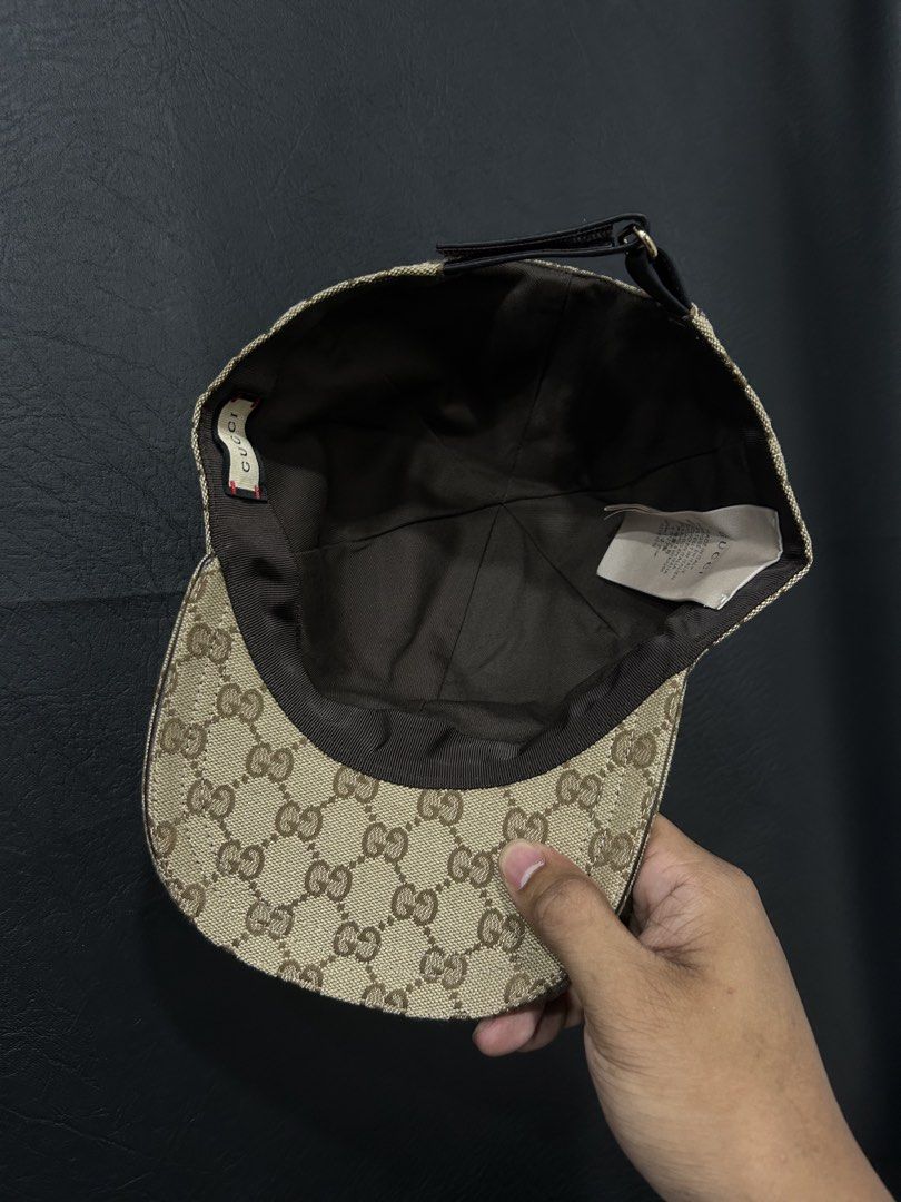 Gucci GG Canvas Baseball Cap Size L (Category: Caps & Hats) located in Manila. Submitted by bodegabodega (Listing ID 1468558521, Image 2). Description: Gucci baseball cap in beige and brown GG canvas pattern. Features the classic green and red web stripe on the sides. Adjustable brown leather strap at the back with debossed Gucci logo and serial number 200035 601491. Size L, 59 cm. Brown interior lining with Gucci fabric tag and care labels intac