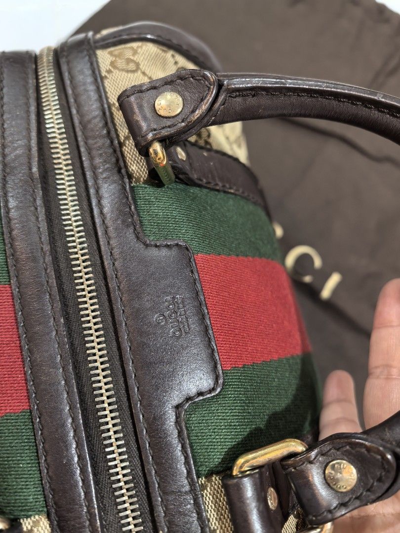 Gucci GG Canvas Web Boston Bag (Category: Luxury Bags & Wallets) located in Manila. Submitted by jsu2026 (Listing ID 1468652449, Image 3). Description: [AUTHENTIC] Gucci GG Canvas Vintage Web Small Boston Bag (Size 25) Selling my timeless, pre-loved Gucci Boston bag. This is the highly coveted 2-way version featuring the classic green and red web stripe paired with signature dark brown leather trim. It can be carried comfortably as a top handle o