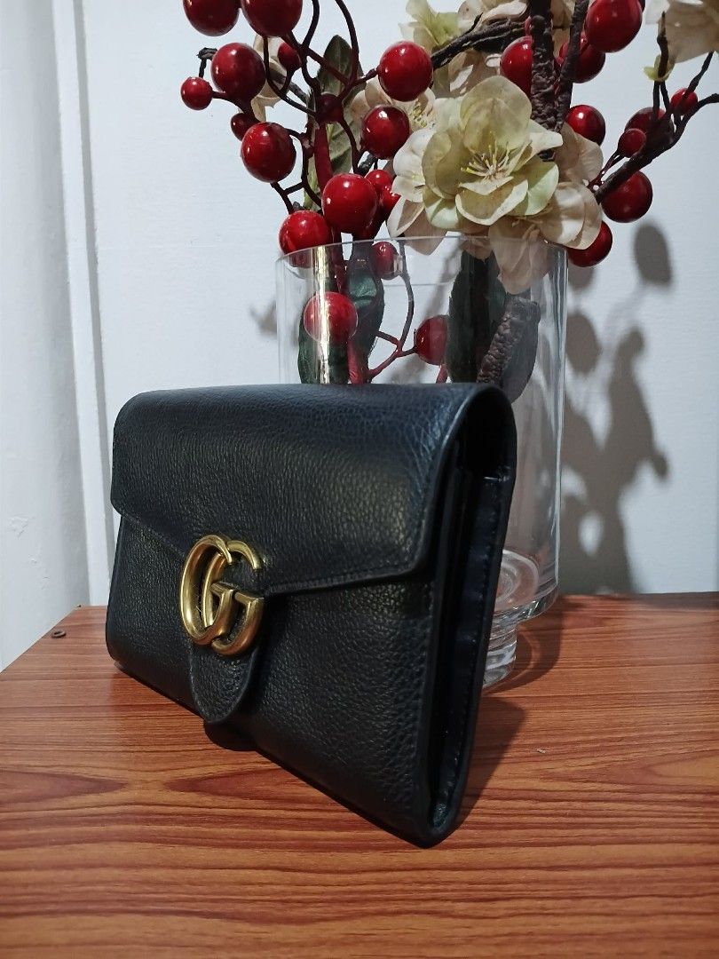 GUCCI GG MARMONT WALLET (Category: Wallets & Card holders) located in Davao. Submitted by garryalbar82591 (Listing ID 1468513740, Image 2). Description: •NGA •Coded •Crafted in black textured calfskin leather and accented with iconic antique gold-toned DOUBLE G HARDWARE. •Structured envelope flap silhoutte and elegant grained finish. •Function as a long clutch wallet Excellent condition •No Issue •I have a spare chain strap (silver hardware only)