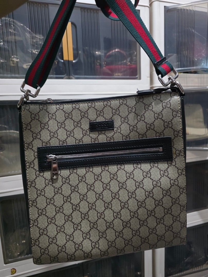 Gucci GG Supreme Messenger Bag (Category: Sling Bags) located in Lemery. Submitted by venus23 (Listing ID 1468656253, Image 1). Description: Gucci messenger bag in GG Supreme canvas. Black leather trim and front vertical zip pocket. Green and red web strap attached. Leather tag on the front with Gucci branding. Clean structured shape, daily carry size..