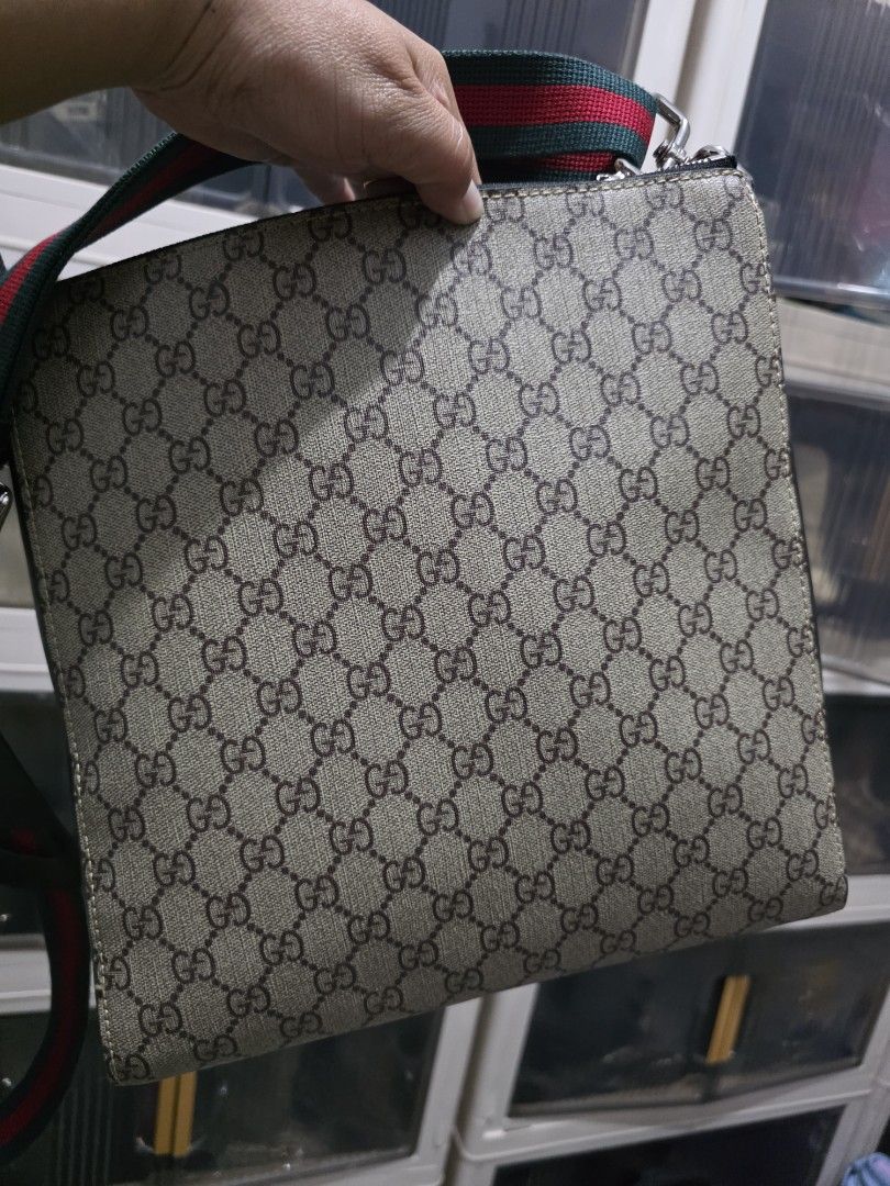 Gucci GG Supreme Messenger Bag (Category: Sling Bags) located in Lemery. Submitted by venus23 (Listing ID 1468656253, Image 3). Description: Gucci messenger bag in GG Supreme canvas. Black leather trim and front vertical zip pocket. Green and red web strap attached. Leather tag on the front with Gucci branding. Clean structured shape, daily carry size..