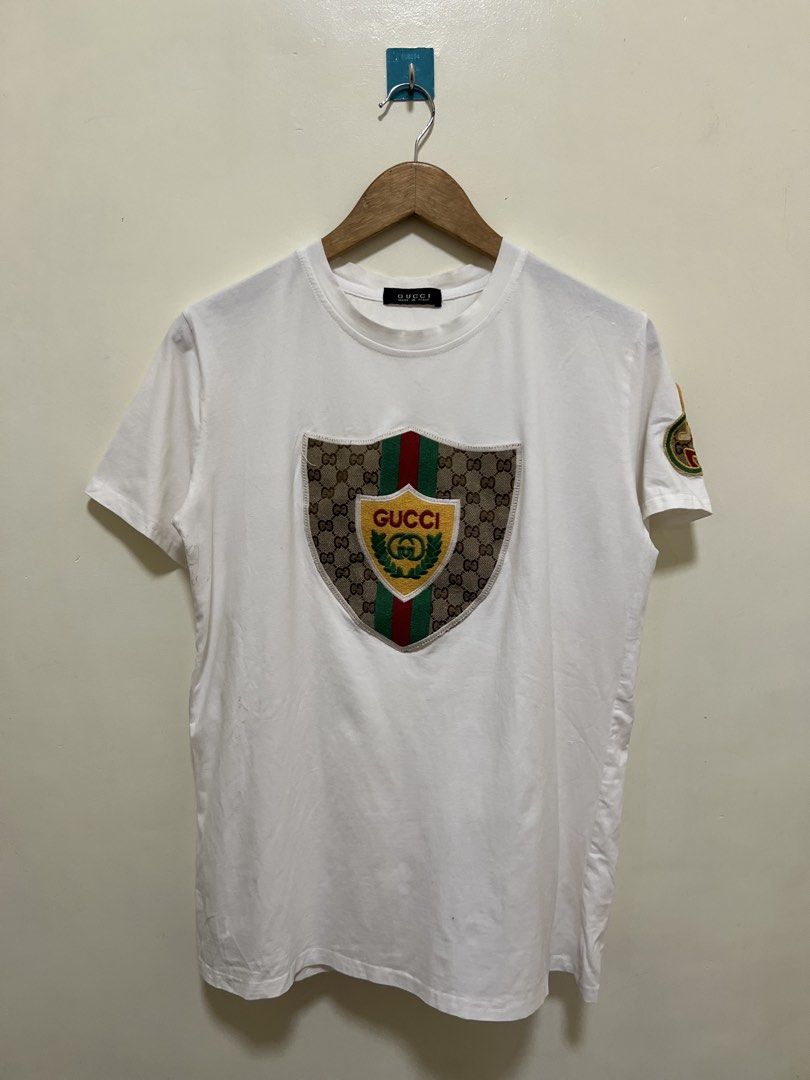 Gucci Patch Logo Design White Shirt (Category: Shirts) located in Manila. Submitted by thriftpoint99 (Listing ID 1468690242, Image 1). Description: 20.5x27 Issue pinhole and cutwashtags Excellent condition.